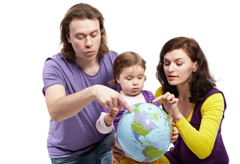 Father and mother show something on inflatable ball-earth