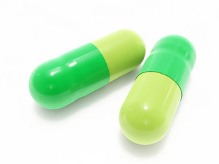 Two green pills on white background, isolated
