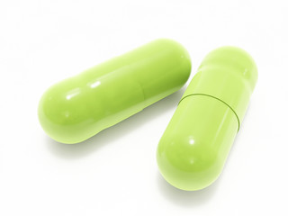 Two green pills on white background, isolated