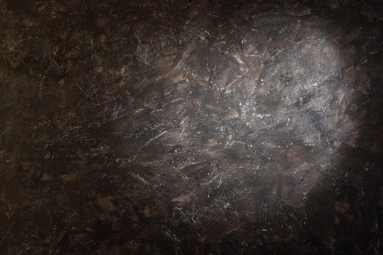 Splotch on dark brown background with spots inside studio