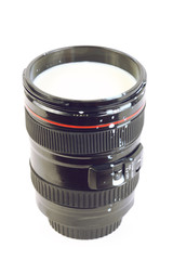 Professional camera lens with milk, souvenir isolated