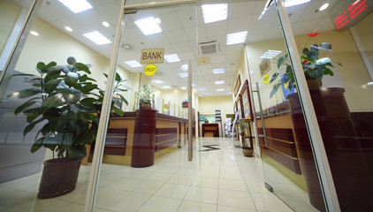 Office entrance area of bank with reception counter;