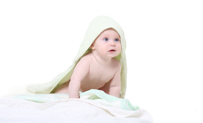 Happy baby with green towel.Age of 8 months.