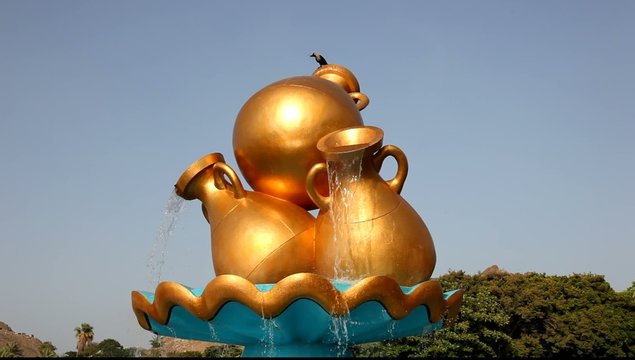 Golden water jug at a roundabout in Muscat, Oman