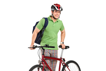 Fototapeta premium Young bicyclist posing next to a bicycle