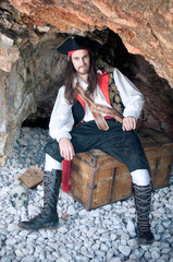 Pirate siting on treasure trunk