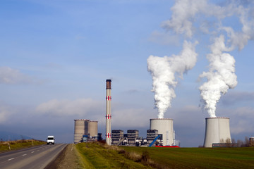 Power Station chimneys smoke, and knows the road.
