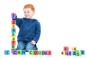 Boy counting numbers with kids blocks