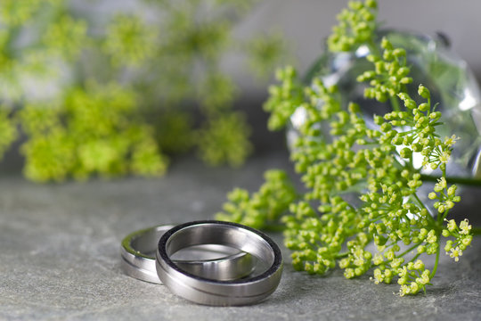 Wedding rings and green flowers