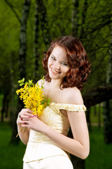 portrait of young girl with bunch of yellow flowers in wedding c