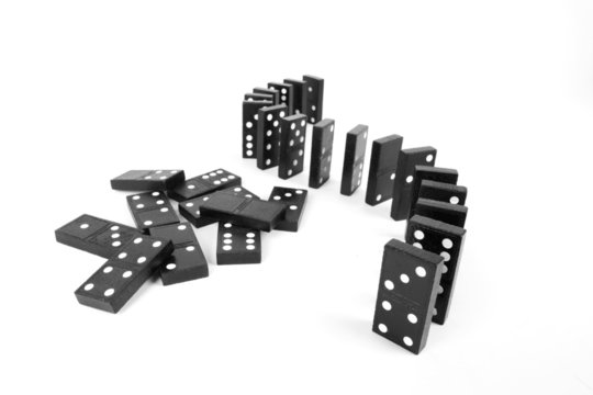 Domino line up curve and a pile of black wooden domino.