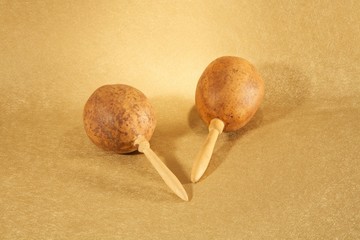 two maracas on golden paper