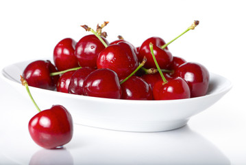 Naklejka na ściany i meble Fresh cherry berries in a plate
