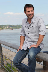 Man sitting by river.