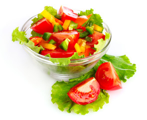 many vegetables on the plate isolated on white