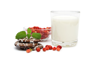 Glass of milk with wild strawberries and cookies