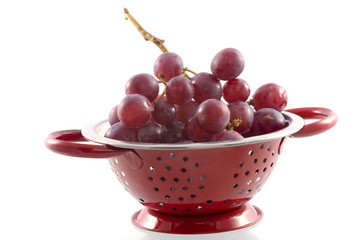 a colander with grapes