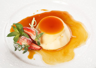 Dessert panna cotta on white plate decorated with strawbery, min