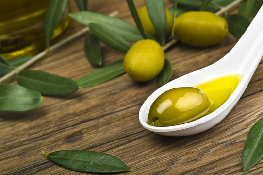 green olives and oil on the spoon