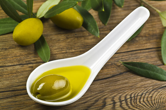 green olives and oil on the spoon ..