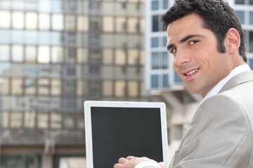 Businessman using a laptop with a blank screen