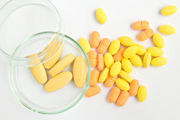 yellow pills on white background