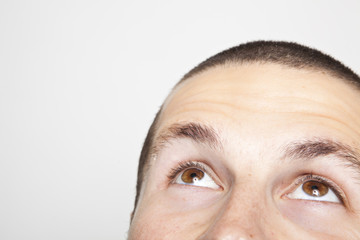 young man's face, looking up