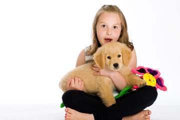 kid holding a puppy