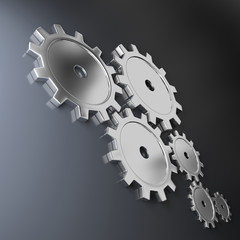 Metallic cog-wheels on a dark background