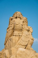 Fototapeta premium Sirens, sand sculpture in the sky