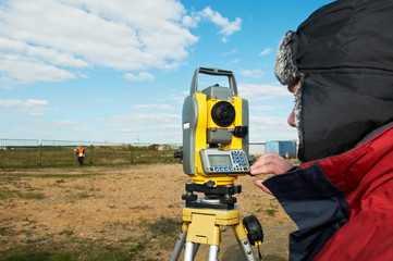 surveyor works with theodolite tacheometer