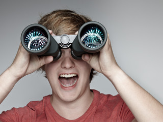 Attractive young man with spyglass looking for the future