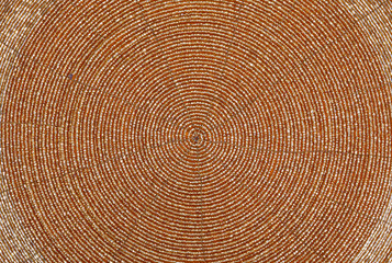 Golden beadwork texture background with round lines pattern