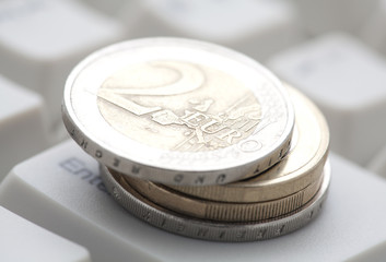 Euro coins over computer keyboard
