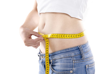 young woman measuring her waist