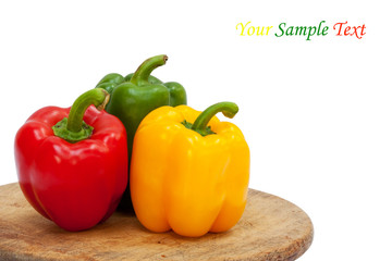 Three sweet peppers in yellow, red and green color
