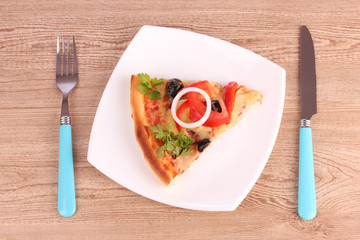 tasty pizza with olives and cutlery on a wooden background