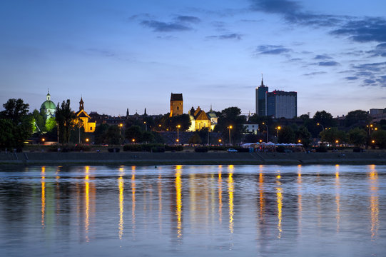 Warsaw durung sundown with reflection in Vistula river