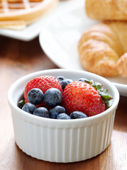 breakfast setting with blueberries and strawberries.