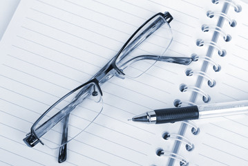 Glasses,pen and notepad