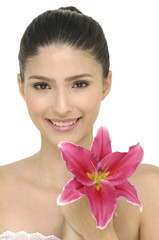 Beautiful young woman with pink lily