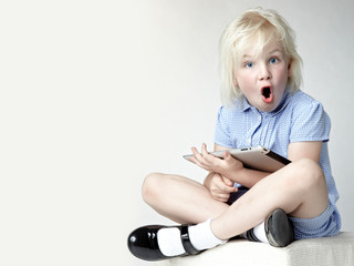 Surprised looking girl surfing on the internet
