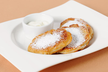 Thick pancake of the cottage cheese with sour cream