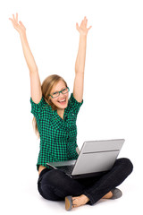 Girl with laptop raising her arms in joy