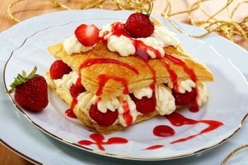Puff pastries  with strawberries and berry sauce.