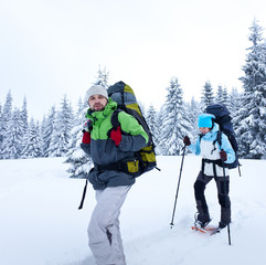 Hiker walks in snow forest