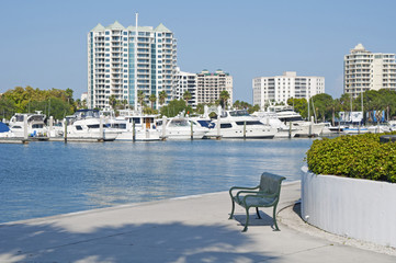 Green metal bench at the Sarasota marina.
