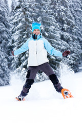 Fototapeta na wymiar Hiker jumps in snow
