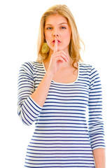 Alert beautiful teen girl  with finger at mouth. Shh gesture.