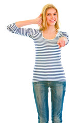 Fototapeta premium Smiling teengirl showing contact me and pointing at you